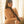 Load image into Gallery viewer, A nude woman with long brown hair stands in front of white curtains. She wears the black Leather Neck-Wrist Restraint, which has a collar around her neck and a vertical strip of leather running down her torso. The strip of leather has two wrist cuffs at the end.
