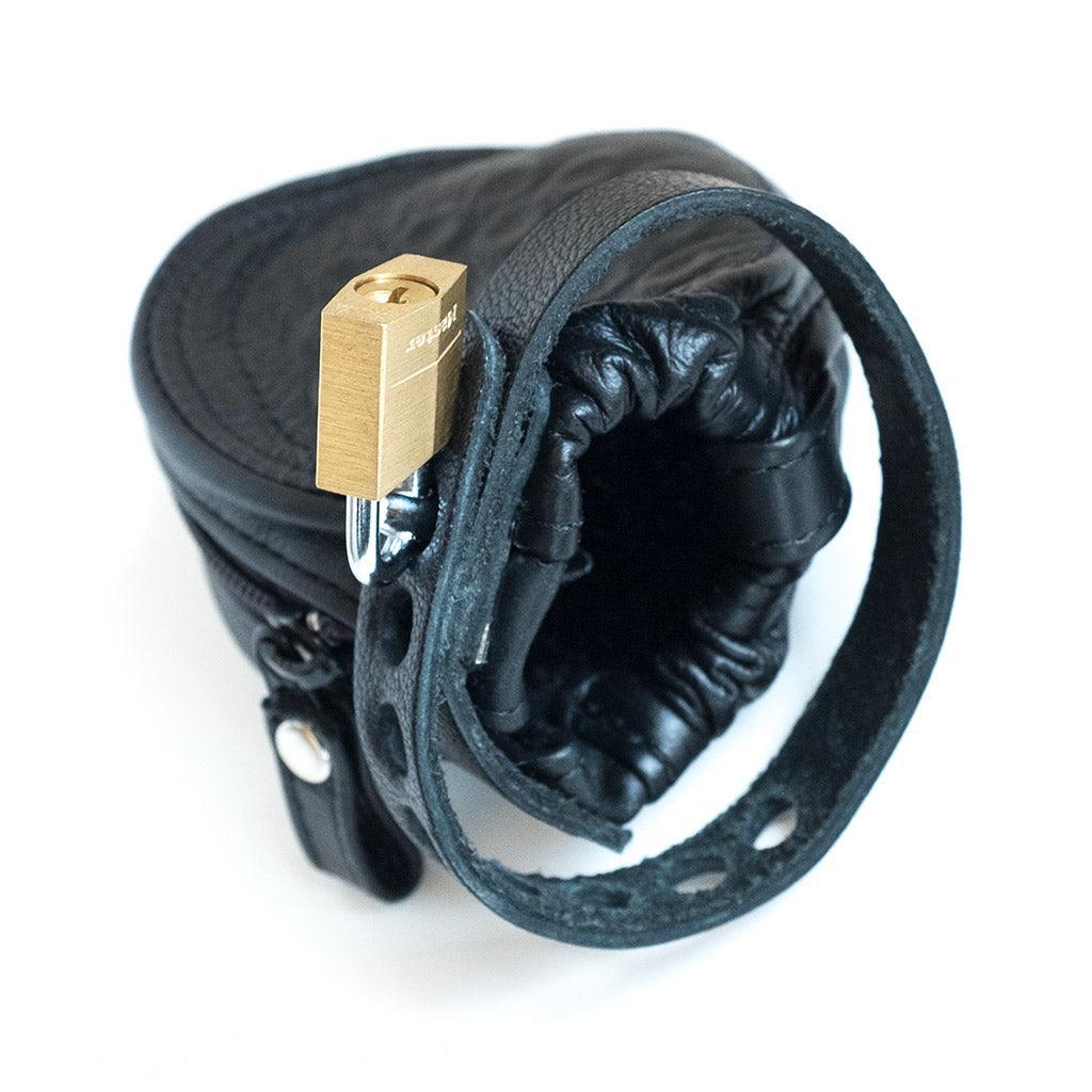 The Penis Prison With Pin Prick Lining and a Leather Cock Strap is displayed against a blank background.