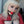 Load image into Gallery viewer, A blonde woman wearing the red Bolero Straitjacket is shown in front of a grey wall. She wears the red Silicone Ball Gag With A Garment Leather Strap. The gag is a medium-sized ball made of bright red matte silicone with a black leather strap.
