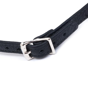 A close-up of the silver buckle closure on the Silicone Ball Gag With A Garment Leather Strap is shown against a blank background.