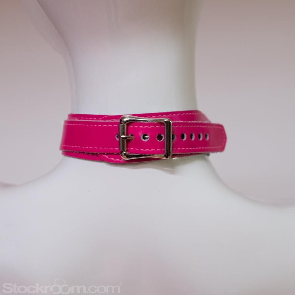 A close-up of the back of the neck of a mannequin wearing the pink Neon Angel Bust Harness is shown. The collar of the harness closes with a silver buckle.