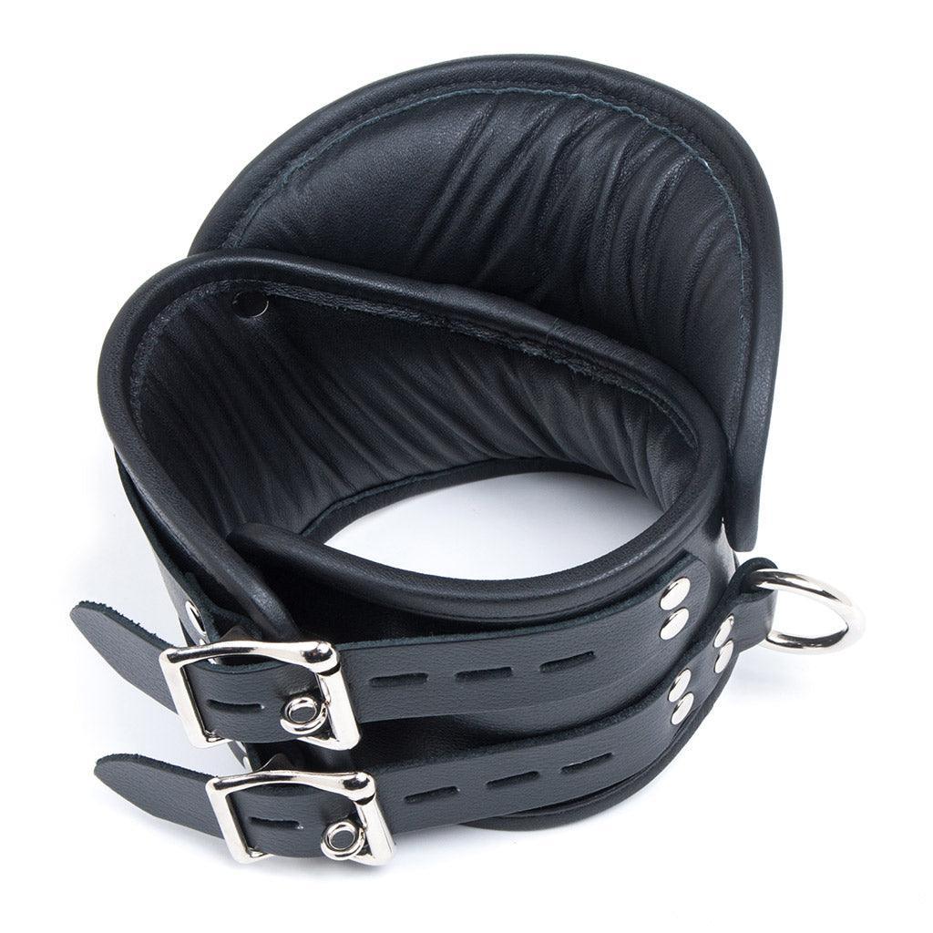 The Deluxe Padded Leather Posture Collar is shown from the back against a blank background. It has two adjustable straps and lockable buckle closures.