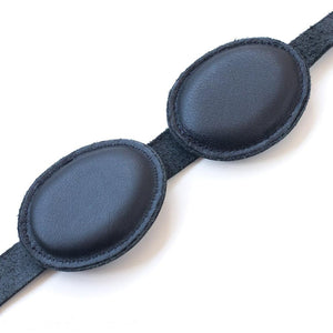 The padded inside eye covers of the Foam Padded Aviator Blindfold are displayed against a black background.