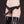 Load image into Gallery viewer, A woman’s body is shown from her waist to her knees against a black background. She wears black latex stockings and the Nancy Strapon Harness with a black dildo attached. The harness is made of black fabric that resembles low-cut panties with a small bow on top.
