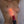 Load image into Gallery viewer, A close-up of a woman&#39;s bare torso is shown. Somebody holds a red Neon Wand up to her torso with the KinkLab Heart-On Neon Wand Electroplay Attachment on it, which glows red. The wand grazes her breast.
