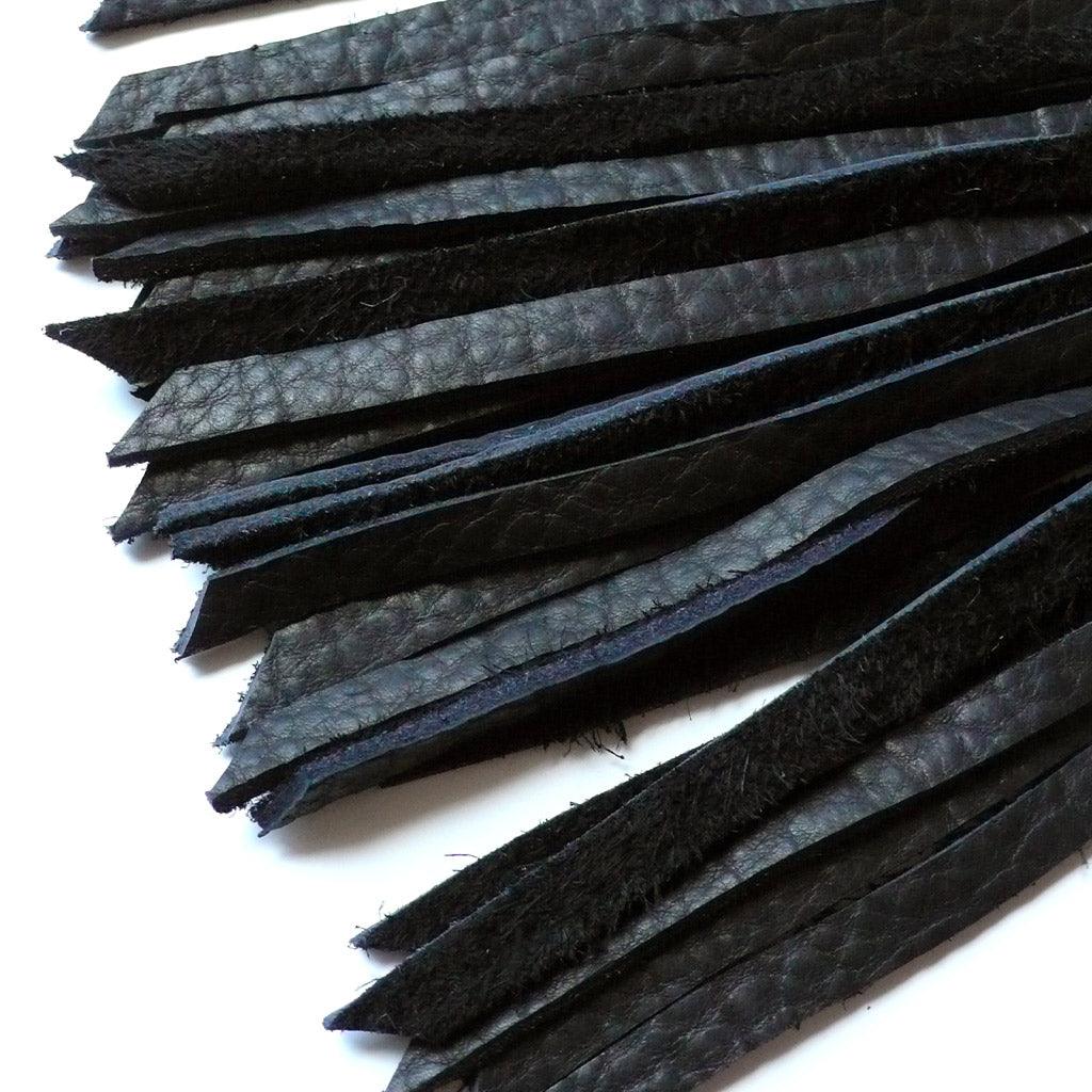 A close-up of the tips of the falls of the 30-inch Elk Hide Floggers in every color is displayed against a blank background.