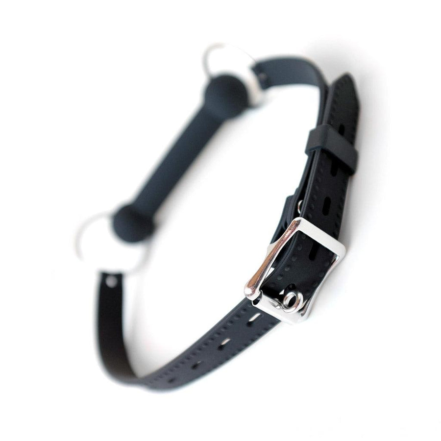 The back of the Silicone Bit Gag With Silicone Strap is displayed against a blank background, showing the silver metal buckle. The gag’s strap is adjustable.