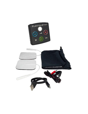 The contents of the The Electrastim Kix Electrosex Stimulator are shown against a blank background. The contents include the Kix Stimulator, two electro pads, an output cable, a charger, and a cloth case.