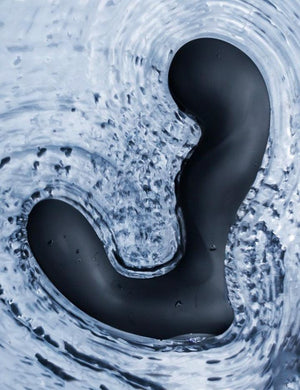 The The Svakom Iker App-Controlled Prostate Vibrator is shown floating in water. The toy’s vibrations are making the water ripple.
