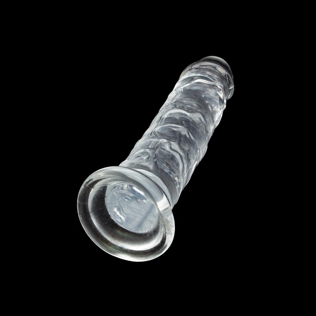The Crystal Addiction Clear Jelly Dildo, 7” on a black background.