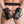 Load image into Gallery viewer, A close-up of a man’s butt in a jockstrap with his hands behind his back is shown. His hands are in the Deluxe Padded black Leather Fist Mitts, which are attached to each other by a metal snap hook connected to their D-rings.
