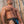 Load image into Gallery viewer, A muscular man with chest hair stands in front of a wooden fence wearing the Color Coded Jockstrap. The Jockstrap is made of black leather and has a vertical strip of blue leather in the center.
