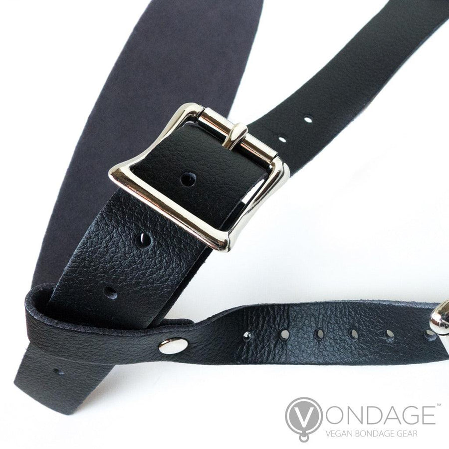 A close-up of the side of the Vondage Strapon Dildo harness is shown against a blank background, displaying the adjustable waist band and leg straps and their buckles.