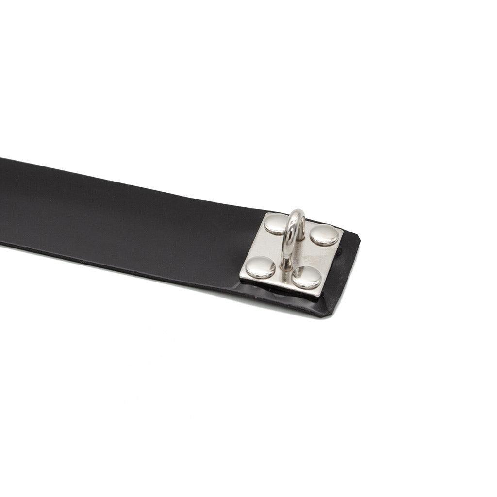 A closeup of the hardware of the Stockroom Black PVC Collar with a D-Ring is shown against a blank background.