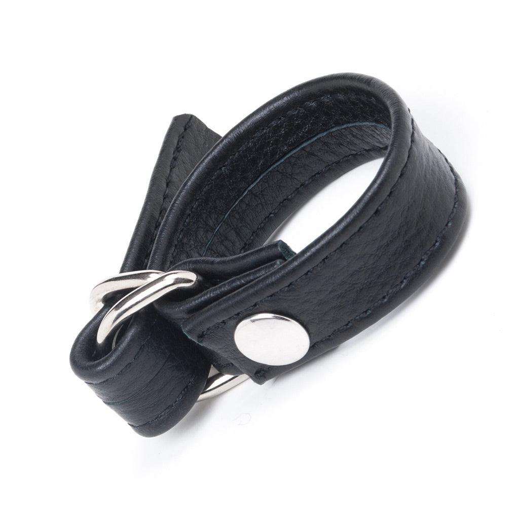 A Leather Cock Ring with D-Ring, Black made by The Stockroom and Stormy Leather is shown displayed in front of a white background.