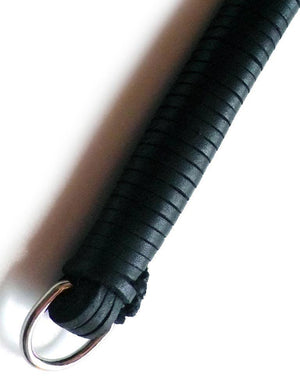 A close-up of the black leather 20-inch Thong Whip with Spiked Tails leather-wrapped handle with a D-ring at the end is displayed against a blank background. 