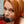 Load image into Gallery viewer, A close-up of a red-haired woman shows her with the Tantus Silicone Fantasy Penis Gag in her mouth.
