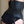 Load image into Gallery viewer, A close-up of a woman&#39;s back in the Full Curves black leather Ophelia Corset is shown. The corset has silver metal grommets and laces up the back.
