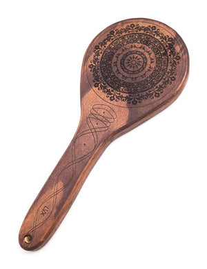 The Floral Engraved Wood Spanking Paddle, a light brown wooden ping-pong style paddle with a floral design engraved on it, is displayed against a blank background.