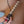 Load image into Gallery viewer, An extreme close-up of a woman’s thigh and hip is shown. She holds the Electrastim Wave Electro Dildo near her inner thigh. The dildo is made of metal and is bumpy from the tip to the base, which is wrapped in a black cord. Two thin cords are plugged into the base of the dildo.
