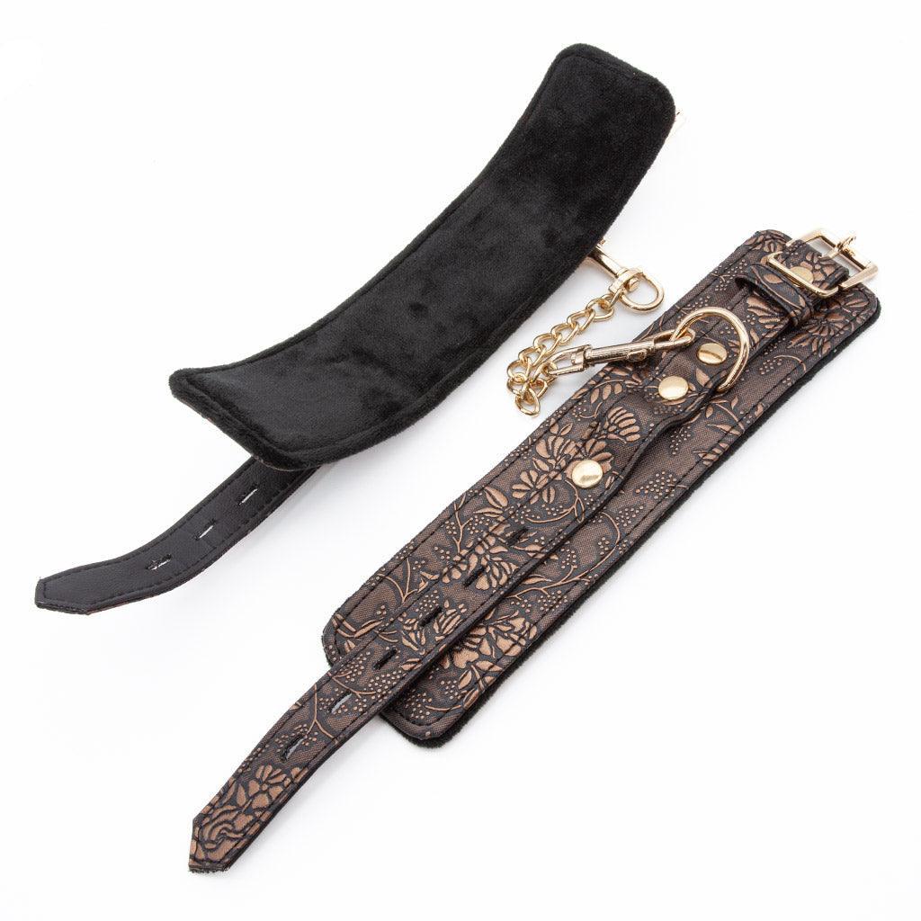 A pair of uncuffed Vegan Floral Ankle Cuffs With Faux Fur are displayed against a blank background, one showing the outside of the cuff and one showing the inside. The cuffs are lined with black faux fur.