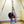 Load image into Gallery viewer, A woman is shown suspended from the Tetruss Maxximus Suspension Bondage Frame. She is suspended by her leg, which is tied in a bent position. Her brown hair hands down as she lowers her head.
