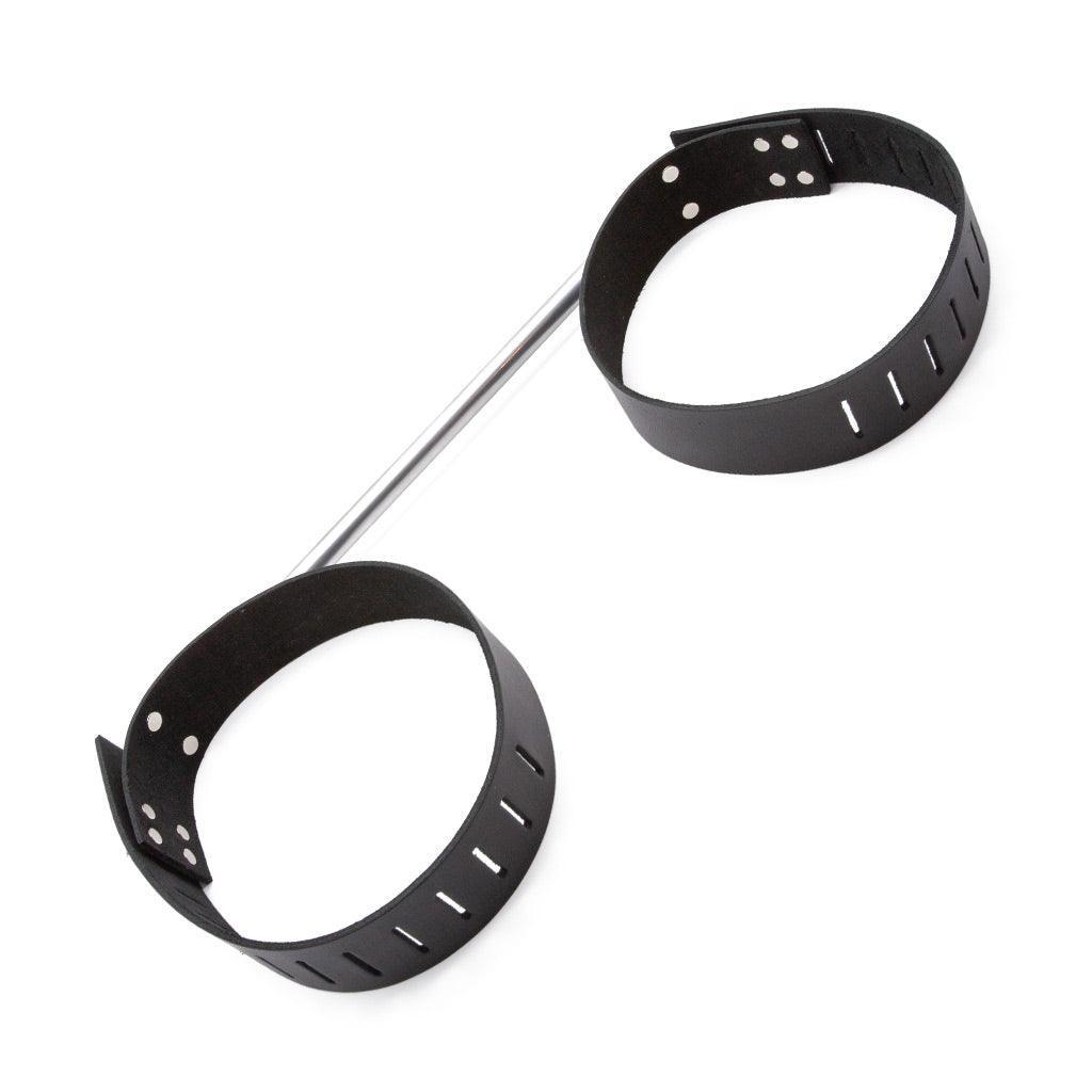 The chrome Thigh Spreader Bar is shown against a blank background. It is made of a chrome rod with two metal eye holes facing outwards. On each end of the bar, there are adjustable black leather thigh cuffs with hasp closures.