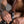 Load image into Gallery viewer, A close-up of a man&#39;s thigh is shown. He is putting on the black Leather Thigh Dildo Strap with a brown dildo attached.
