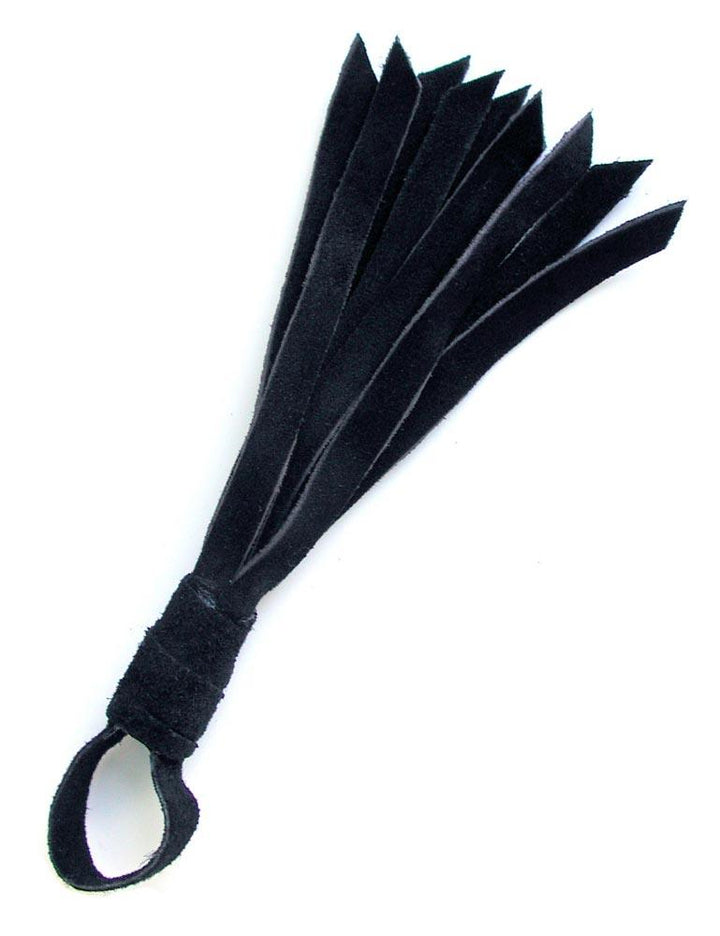 The black Teeny Weeny Leather Flogger from The Stockroom is shown against a blank background. It is a mini flogger made of black suede with a tiny handle and loop at the end.