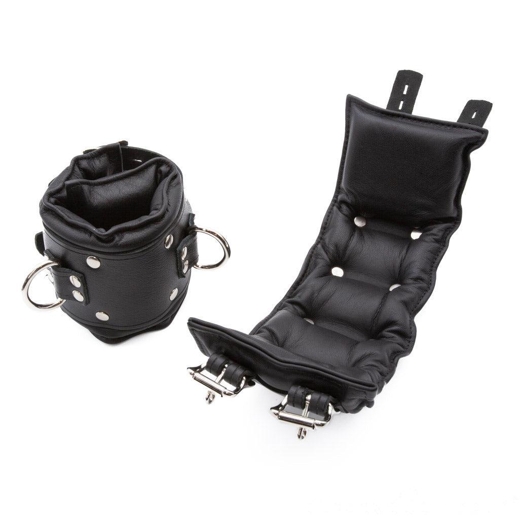 The Premium Lockable Dungeon BDSM Leather Ankle Cuffs are shown against a blank background. They are made of black leather with silver hardware. The cuffs are wide and padded. They have a D-ring and two adjustable straps with lockable buckles.