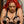 Load image into Gallery viewer, A woman in a metal chair is wearing Master G&#39;s Bondage Bra. It has black leather straps that go over her shoulders and around her breasts, which are squeezed by strings that are attached to the straps around her breasts and the leather nipple shields.

