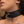 Load image into Gallery viewer,  A close-up of a woman’s neck is shown. She is wearing the Vondage Locking/Buckling Collar, which is made of black faux leather with silver hardware, including a D-ring. The collar is locked with a small silver padlock.
