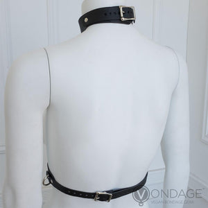 The Vondage Vegan Leather Bust Harness is displayed on a female mannequin from the back. The straps on the neck and around the waist are adjustable and fasten with metal buckles.
