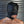 Load image into Gallery viewer, A shirtless man’s head is shown from the front. He stands in front of a metal wall and is wearing the Open Mouth Leather Bondage Hood. The hood has silver metal grommets and black laces on the sides.
