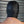 Load image into Gallery viewer, A shirtless man’s head is shown from the back. He stands in front of a metal wall and is wearing the Open Mouth Leather Bondage Hood. The hood has silver metal grommets and black laces on the sides.
