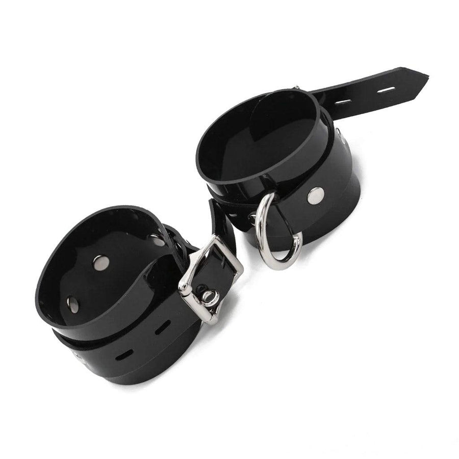 Stockroom Black PVC Wrist Cuffs are shown buckled against a blank background.