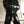 Load image into Gallery viewer, A man is shown standing in a kitchen wearing the black Latex Bondage Suit. The suit has a collar with a D-ring and no sleeves. His arms are crossed, and under his arm is a belt. The suit cuts off at the mid-thighs.
