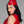 Load image into Gallery viewer, A woman with black hair and red lipstick wearing a red latex top poses in front of a grey background. She also wears the Latex Garrison Cap by Syren latex in red with blue trim.
