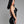 Load image into Gallery viewer, A woman with black hair and red lipstick poses in profile in front of a grey background. She wears the Latex Halter Dress in black from Syren Latex.
