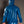 Load image into Gallery viewer, A man poses in front of a grey background, facing away from the camera. He wears blue latex pants and the Executioner Hoodie by Syren Latex in transparent blue with the hood up. 
