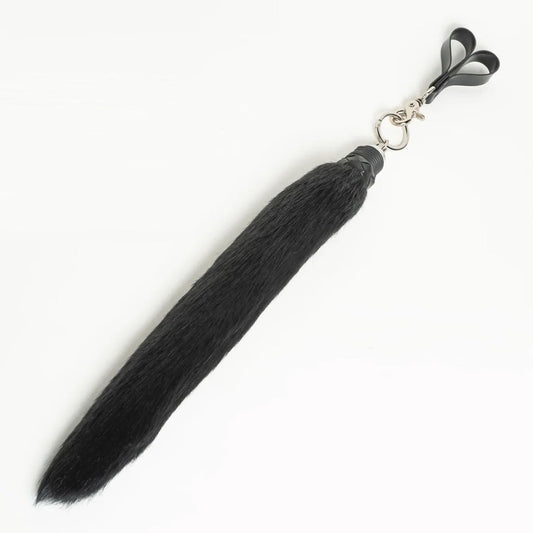 Black faux fur finger flogger on a white background