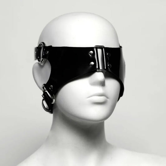 Black rubber blindfold on a white mannequin head against a white background shot at an angle. 