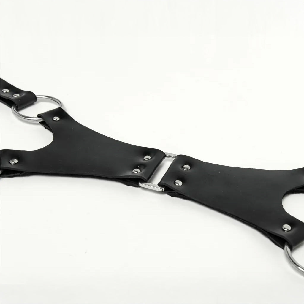 Black rubber blindfold with metal clasp on a white background