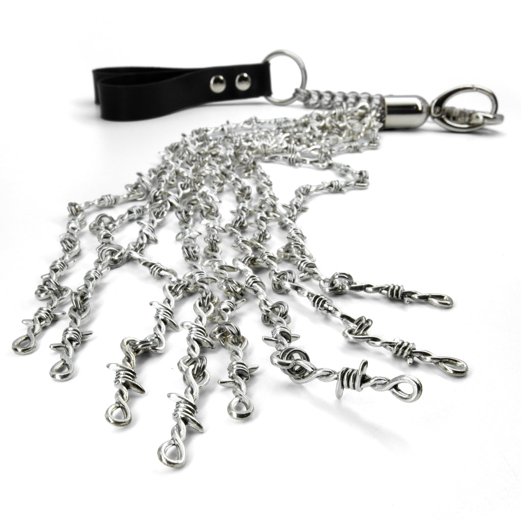 A close-up of the ends of the Kanuka barbed white finger flogger is shown on a white background.