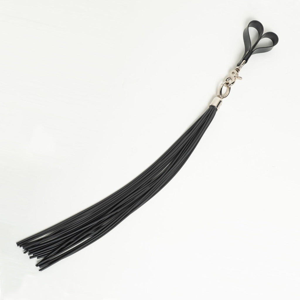 Black rubber cord flogger with finger loops on a white background