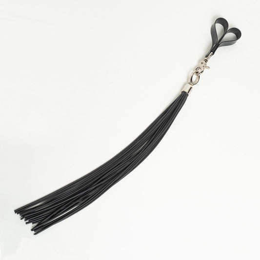 Black rubber cord flogger with finger loops on a white background
