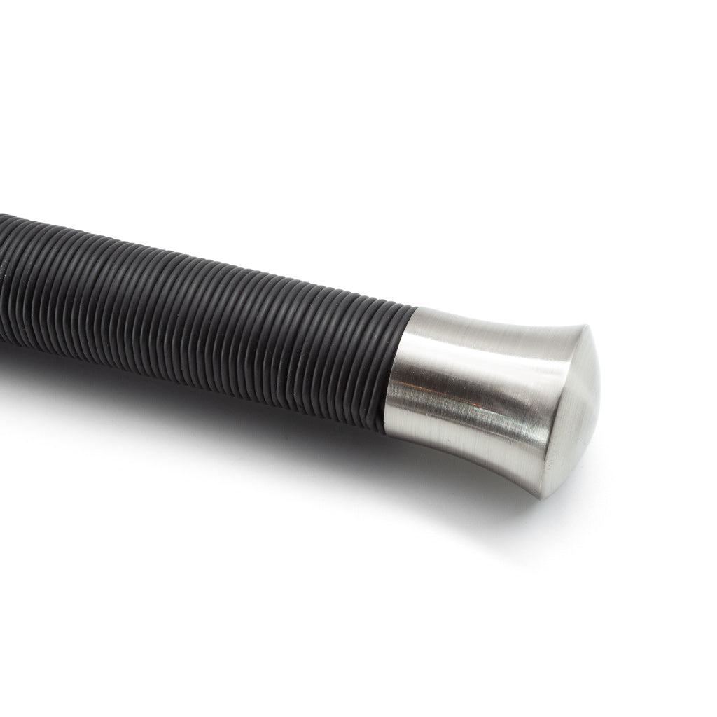 Metallic rod with coiled spring on a white background