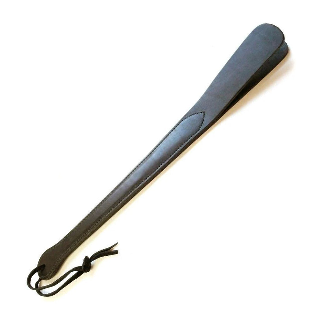 The black Leather Slapper for impact play is displayed against a blank background. It has a wrist loop at the bottom of the handle.