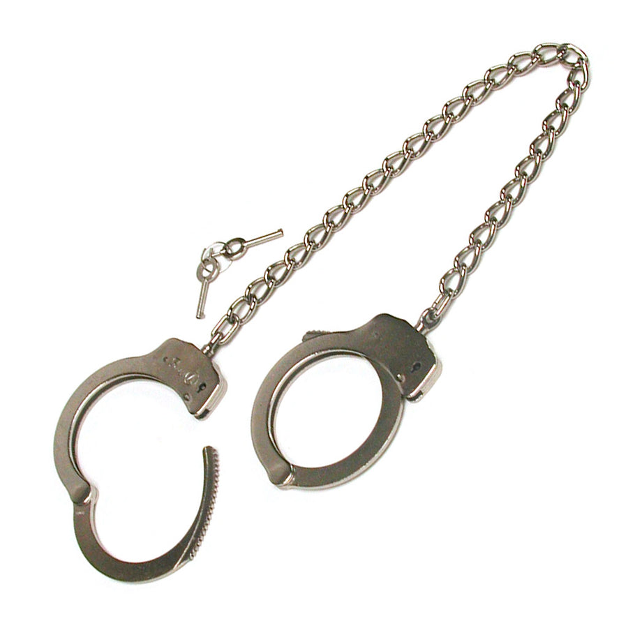 The silver Double Lock Legcuffs are displayed against a blank background with their keys. They resemble basic police cuffs with a long chain connecting them.