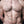 Load image into Gallery viewer, A close-up of a muscular man’s bare torso with some body hair is shown. He wears the silver Mini Nipple Clamps.
